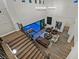 Stunning living room with high ceilings, modern chandeliers, and a wall of glass overlooking an outdoor seating area at 11906 Port Labelle Dr, Las Vegas, NV 89141
