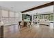 Open concept living and dining room with modern furniture, exposed beam, hardwood floors, and access to the outdoor patio at 11906 Port Labelle Dr, Las Vegas, NV 89141
