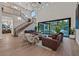 Bright and airy living room with hardwood floors, statement staircase, and an open layout to the backyard at 11906 Port Labelle Dr, Las Vegas, NV 89141