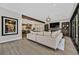 Modern living room boasts hardwood floors, stylish decor, a glimpse of the kitchen and access to the outdoor patio at 11906 Port Labelle Dr, Las Vegas, NV 89141