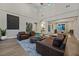 Open-concept living room featuring high ceilings, modern furnishings, and a smooth flow to the dining area at 11906 Port Labelle Dr, Las Vegas, NV 89141