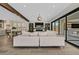 Living room with hardwood floors, exposed wood beam, backyard patio access, modern furniture, and a glimpse of the kitchen at 11906 Port Labelle Dr, Las Vegas, NV 89141