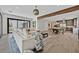 Open concept living room with a comfortable couch, coffee table, wood beam, hardwood floors, and backyard patio access at 11906 Port Labelle Dr, Las Vegas, NV 89141