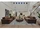 Grand living room with high ceilings, leather furniture, and elegant decor create a luxurious ambiance at 11906 Port Labelle Dr, Las Vegas, NV 89141