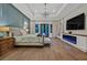 Luxurious main bedroom featuring a fireplace, tray ceiling, hardwood floors, and French doors at 11906 Port Labelle Dr, Las Vegas, NV 89141