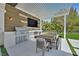 Gourmet outdoor kitchen with a built-in grill and TV, perfect for alfresco dining and entertaining at 11906 Port Labelle Dr, Las Vegas, NV 89141