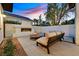 Outdoor living space with a stone fireplace, comfortable seating, and tranquil setting perfect for relaxation at 11906 Port Labelle Dr, Las Vegas, NV 89141