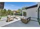 Outdoor patio area features modern seating, an umbrella, and a fire pit, perfect for entertaining guests at 11906 Port Labelle Dr, Las Vegas, NV 89141