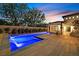 Elegant pool with cascading water features, framed by lush landscaping and a tranquil seating area at 11906 Port Labelle Dr, Las Vegas, NV 89141