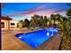 Beautiful pool area features a sparkling blue pool, sun loungers, and a cozy outdoor dining space at 11906 Port Labelle Dr, Las Vegas, NV 89141