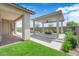 Backyard features a patio cover, zero-scaped landscaping, artificial turf, and a pool at 11909 Pippa Ave, Las Vegas, NV 89138