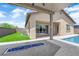Backyard patio showcasing a modern fire pit and seamlessly connected in-ground pool, creating an inviting outdoor space at 11909 Pippa Ave, Las Vegas, NV 89138