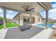Inviting backyard featuring covered patio, modern fire pit, and refreshing in-ground pool, perfect for outdoor entertaining at 11909 Pippa Ave, Las Vegas, NV 89138