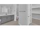 Bright bathroom features gray vanity and opens to water closet and walk-in closet at 11909 Pippa Ave, Las Vegas, NV 89138