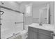 Updated bathroom featuring large glass shower and sink with gray cabinet at 11909 Pippa Ave, Las Vegas, NV 89138