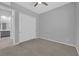 Cozy bedroom features plush carpeting, a ceiling fan and closet with sliding doors at 11909 Pippa Ave, Las Vegas, NV 89138