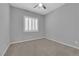Comfortable bedroom with neutral carpet, recessed lighting, and bright plantation shutters at 11909 Pippa Ave, Las Vegas, NV 89138