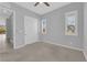 Neutral bedroom features plush carpeting, ceiling fan, and a window with shutters at 11909 Pippa Ave, Las Vegas, NV 89138