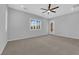 Spacious bedroom features neutral carpet, ceiling fan, and bright window with plantation shutters at 11909 Pippa Ave, Las Vegas, NV 89138