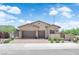 Charming single-story home featuring a three-car garage, desert landscaping, and a tile roof at 11909 Pippa Ave, Las Vegas, NV 89138