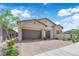 Charming home exterior showcasing a well-manicured front yard, a 2-car garage, and inviting curb appeal at 11909 Pippa Ave, Las Vegas, NV 89138