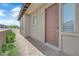 Inviting home featuring a stylish front door, complemented by a well-kept brick pathway and lush, green landscaping at 11909 Pippa Ave, Las Vegas, NV 89138