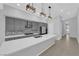 Modern kitchen with stainless appliances, a central island, and stylish pendant lighting at 11909 Pippa Ave, Las Vegas, NV 89138