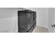Laundry room features stacked washer and dryer on pedestals and tile floors at 11909 Pippa Ave, Las Vegas, NV 89138