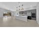 Open-concept living space with modern kitchen, a large island, and sliding glass doors to the patio at 11909 Pippa Ave, Las Vegas, NV 89138