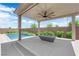 Covered outdoor patio featuring a modern fire pit and views of the private pool at 11909 Pippa Ave, Las Vegas, NV 89138