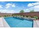 Sparkling in-ground pool with integrated steps, surrounded by lush landscaping and privacy fencing for a serene backyard oasis at 11909 Pippa Ave, Las Vegas, NV 89138