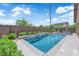 Beautiful in-ground swimming pool and backyard featuring a shaded patio with ceiling fan, perfect for relaxation and enjoyment at 11909 Pippa Ave, Las Vegas, NV 89138