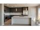 Modern kitchen boasts stainless steel appliances, sleek cabinets, and a marble countertop island at 1321 Blagg, Pahrump, NV 89048