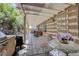 Back patio area featuring a grill, covered seating, and a serene garden setting at 1329 Calle Cantar, Henderson, NV 89012