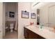 Bright bathroom features a large mirror, double-door cabinets, and tile floors at 1329 Calle Cantar, Henderson, NV 89012