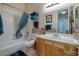 Bright bathroom featuring light wood cabinets, a large mirror, and tile floors at 1329 Calle Cantar, Henderson, NV 89012