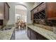Convenient butler pantry with granite counters, wine rack and ample storage at 1329 Calle Cantar, Henderson, NV 89012
