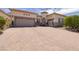 Charming single-story home featuring a decorative front door and a spacious three-car garage at 1329 Calle Cantar, Henderson, NV 89012