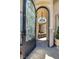 Arched entryway featuring a decorative glass and iron door leading to a private courtyard at 1329 Calle Cantar, Henderson, NV 89012