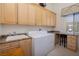 Convenient laundry room with ample storage and a utility sink at 1329 Calle Cantar, Henderson, NV 89012