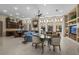 Open-concept living room featuring a cozy fireplace, custom built-ins, and large windows at 1329 Calle Cantar, Henderson, NV 89012