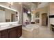 Luxury main bathroom with a jetted tub, dual vanities, and a separate shower area at 1329 Calle Cantar, Henderson, NV 89012