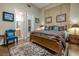 Comfortable main bedroom features a decorative rug, decorative pillows, and ensuite bathroom at 1329 Calle Cantar, Henderson, NV 89012