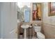 Charming powder room featuring decorative mirror, wall art, and pedestal sink at 1329 Calle Cantar, Henderson, NV 89012
