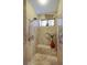 The shower includes two shower heads, built in bench, and a small window for natural light at 1329 Calle Cantar, Henderson, NV 89012