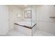 Bright bathroom featuring a bathtub, a glass shower, and a white door at 135 E Harmon Ave # 1703, Las Vegas, NV 89109