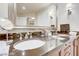 Bathroom featuring a granite countertop with double sinks and a large framed mirror at 135 E Harmon Ave # 1703, Las Vegas, NV 89109