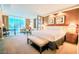 Spacious main bedroom featuring a comfortable bed, seating, and city views at 135 E Harmon Ave # 1703, Las Vegas, NV 89109
