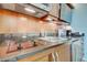 Modern kitchenette equipped with a stovetop, sink, and refrigerator at 135 E Harmon Ave # 1703, Las Vegas, NV 89109