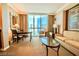 Comfortable living area with city views from a large picture window at 135 E Harmon Ave # 1703, Las Vegas, NV 89109